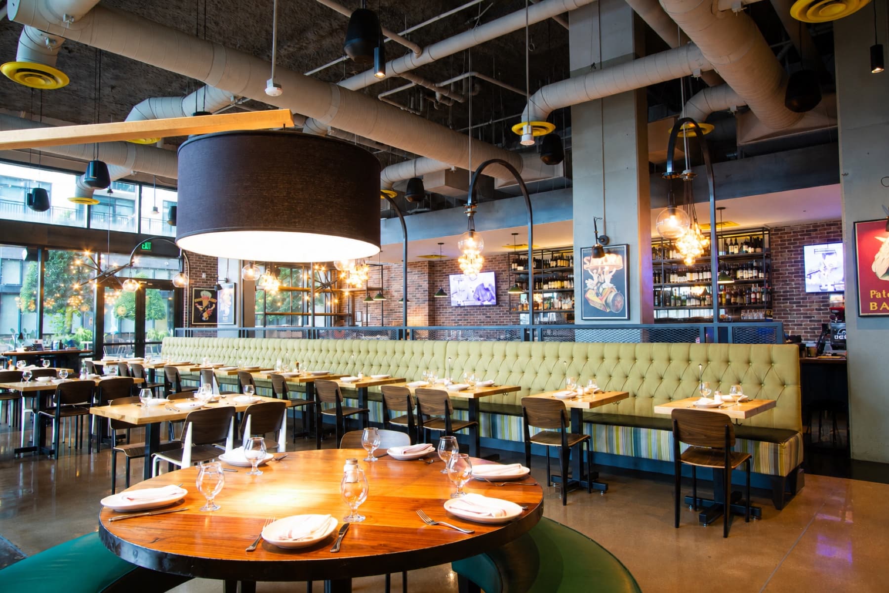 A round table and olive banquettes ready for a weekend gathering at Anthonys in River Oaks