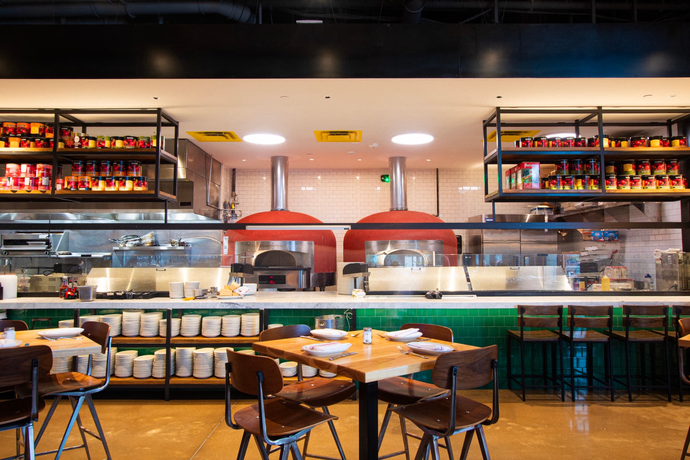 Open kitchen and red pizza ovens at Anthonys New York Italian during lunch service